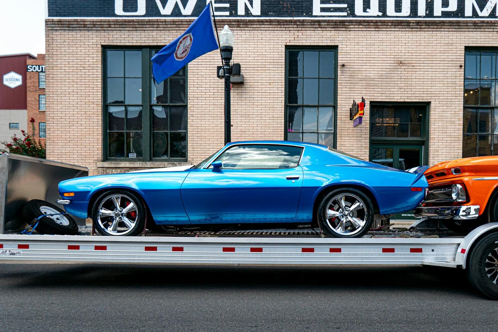 Vibrant blue classic car on a trailer against an urban backdrop in Bristol, Tennessee.